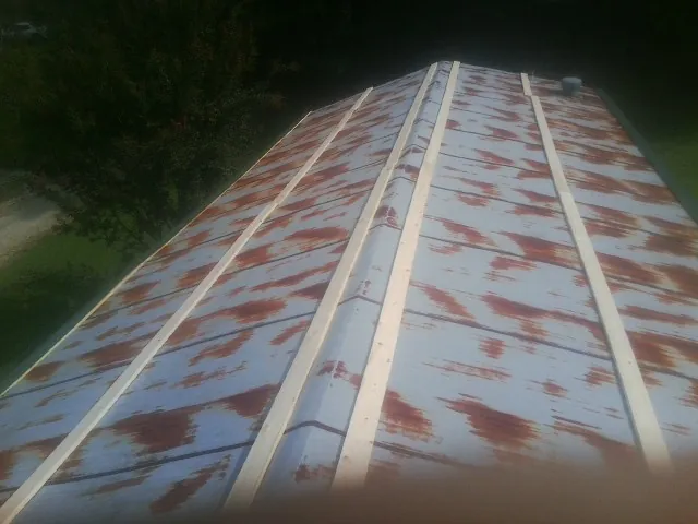 Rusted metal roof panels with new wood purlins before replacement — Storm Damage Roof Repair in Stanardsville by Roofing Brothers